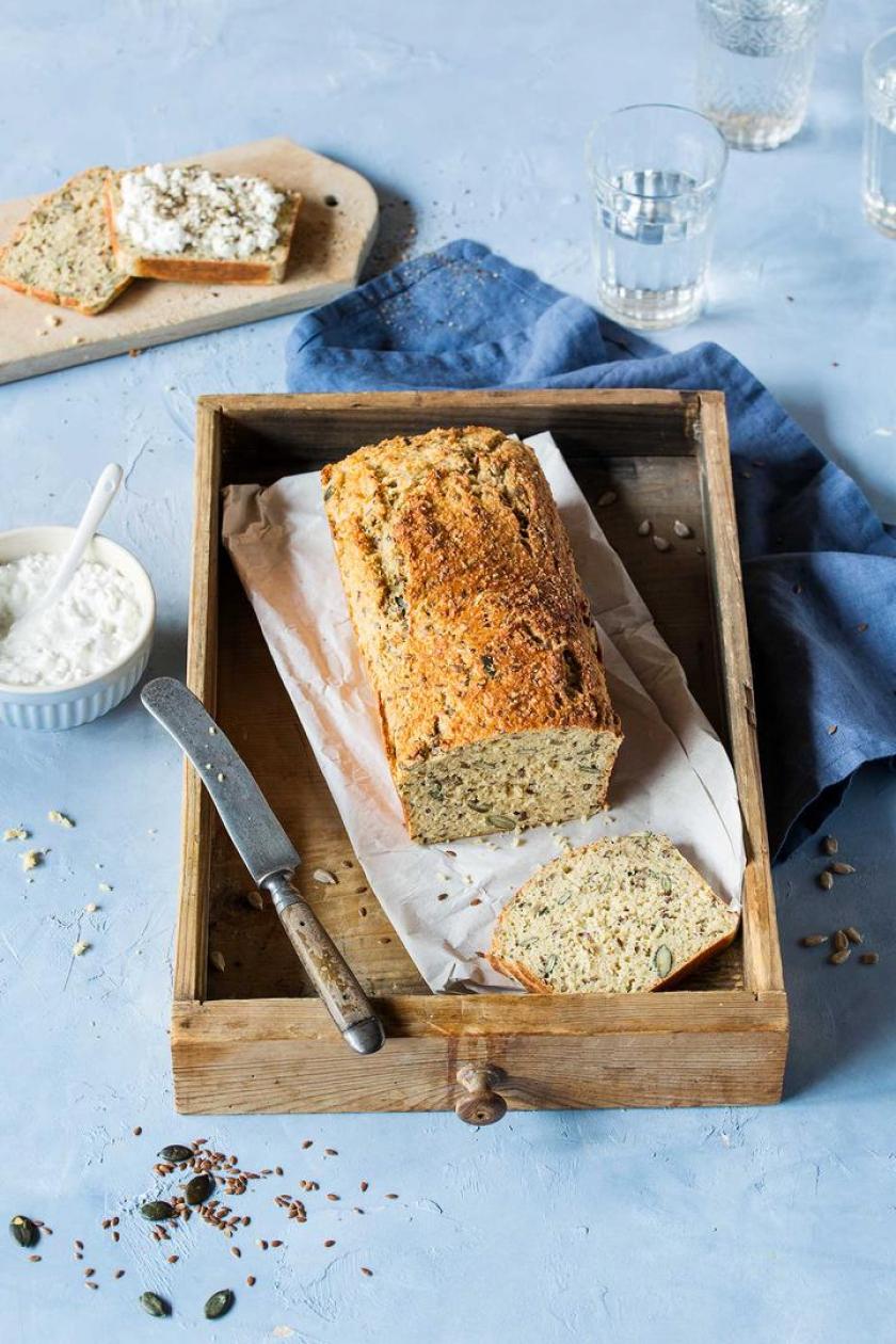 Angeschnittenes Eiweißbrot auf einem Holzbrett.