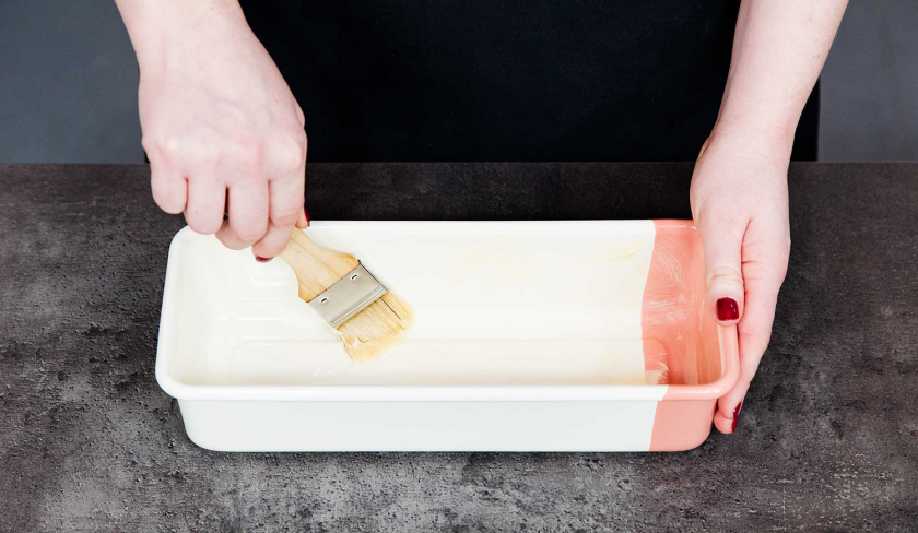 Für das Banana Bread mit Cheesecake-Swirl wird eine Kastenform eingefettet.
