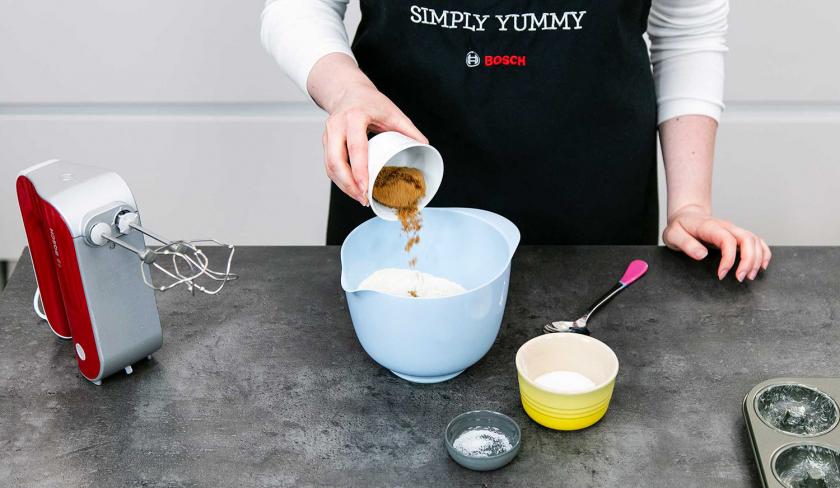 Für die Streusel der Donuts wird Zimt zum Mehl in eine Rührschüssel gegeben.