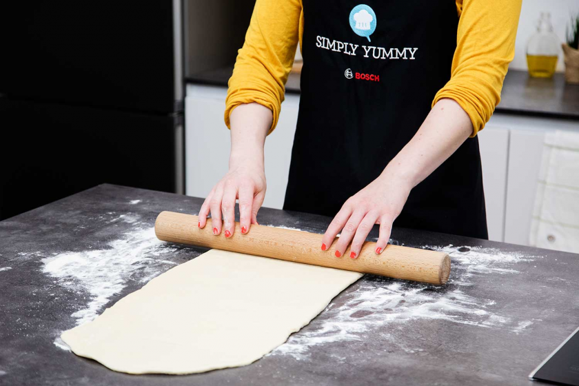 Der Teig für die Franzbrötchen wird ausgerollt.