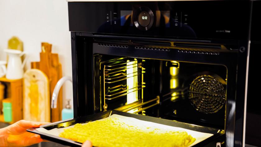 Das Blech mit den Nussecken mit Marzipan wird in den Ofen gegeben.