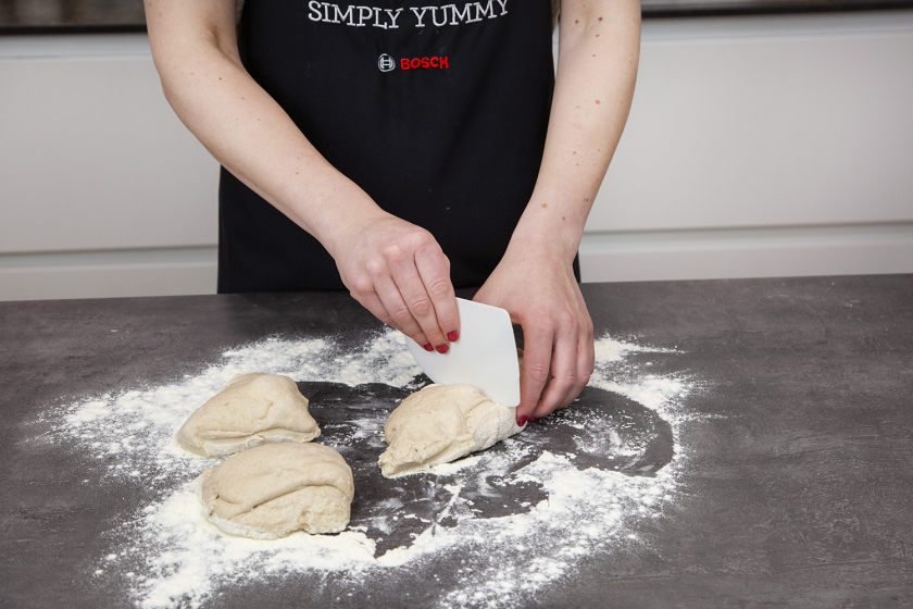 Der Baguette Teig wird in Portionen geteilt.