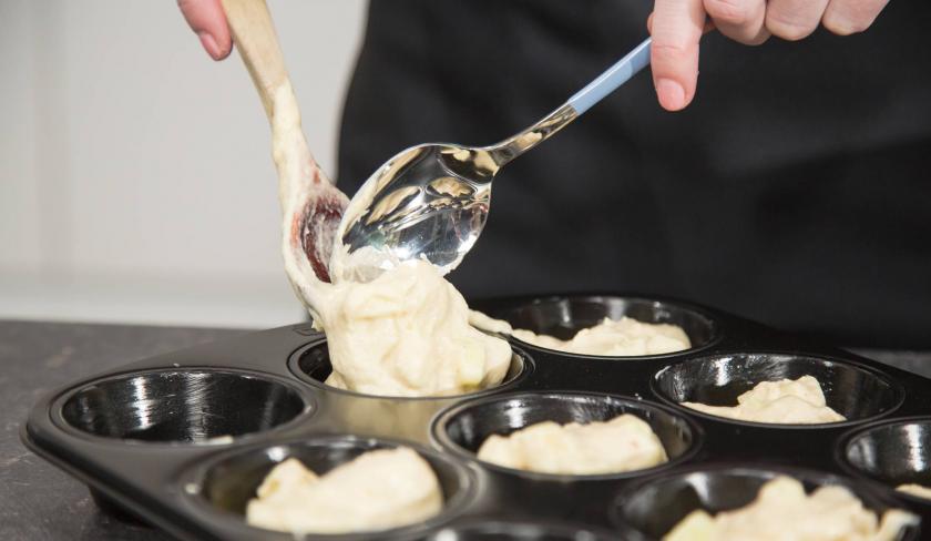 Teig für die Apfel-Zimt-Muffins wird in das Muffinblech gefüllt.