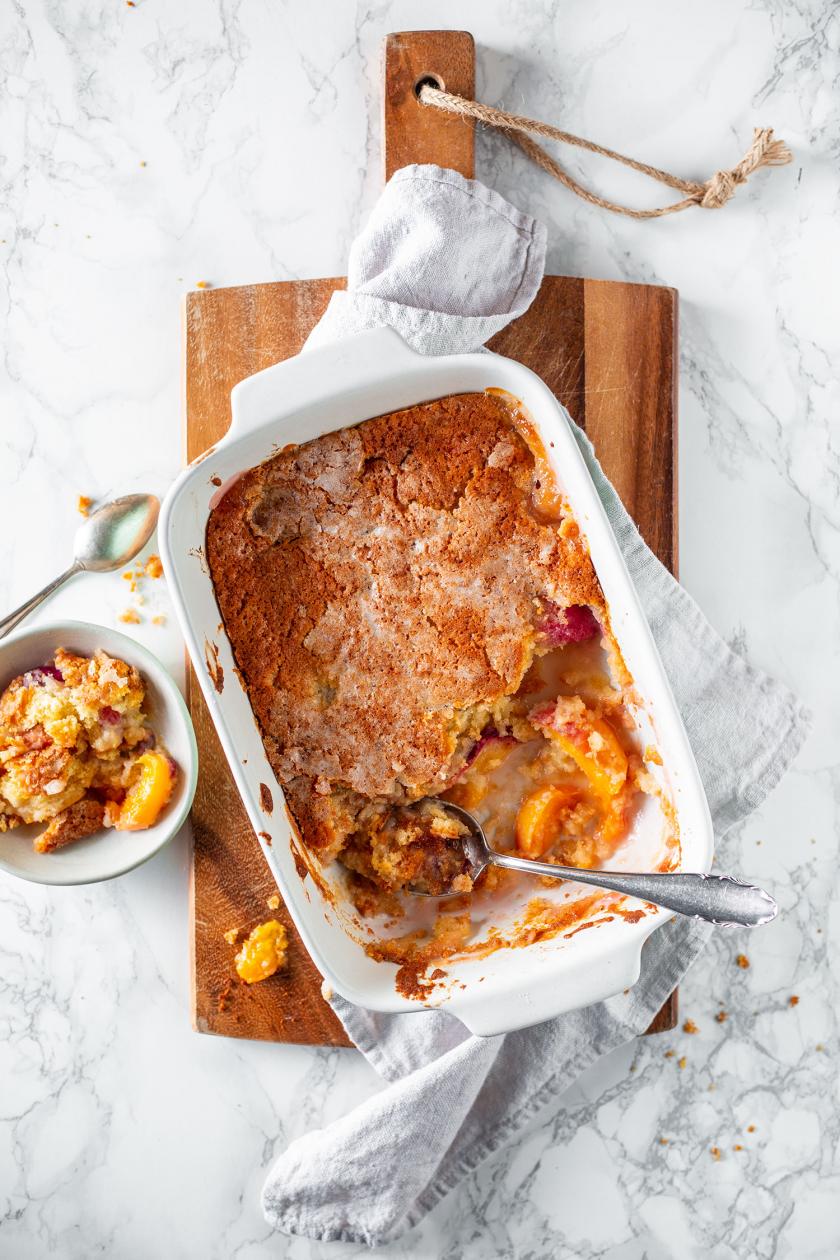 Pfirsich Cobbler in einer Auflaufform mit Löffel.