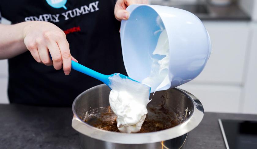 Unter den Teig für die Schoko-Kirsch-Muffins wird Eischnee gehoben.