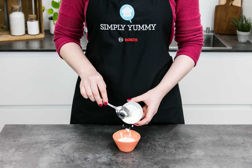 Für Vanillesoße wird Speisestärke in einer Schüssel glatt gerührt.