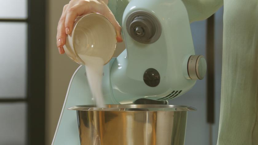 Zucker wird in die Rührschüssel einer Küchenmaschine gegeben.