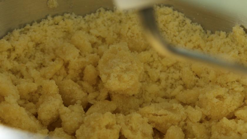 Die Zutaten für den Streuselteig werden in einer Rührschüssel geknetet.